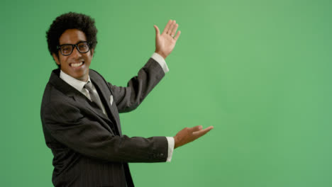 Happy-Businessman-gestures-with-arms-on-green-screen